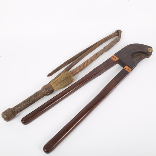 342 - A 19th century rosewood and steel veterinary tail docker tool, by Arnold & Sons of London, and a lea... 