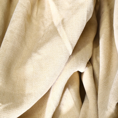 898 - A pair of lined heavy beige curtains, approx 250cm long