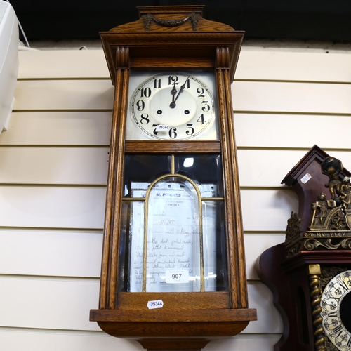 907 - An oak-cased German wall clock with 2-train movement, height 28cm