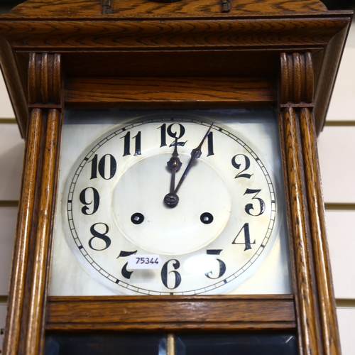 907 - An oak-cased German wall clock with 2-train movement, height 28cm