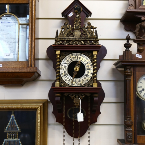 909 - A reproduction brass-mounted wall clock