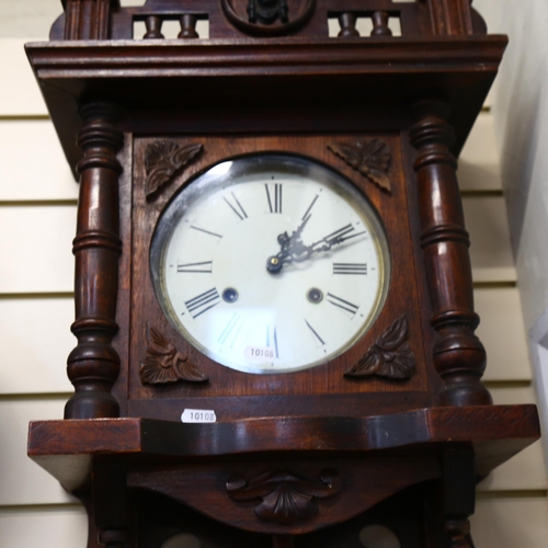 914 - A 1920s oak-cased 8-day wall clock, with pendulum, length 95cm, working order