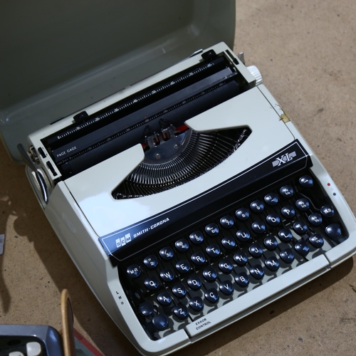 935 - A Smith Corona cased portable typewriter, another, an attache case, and an album of photos and postc... 