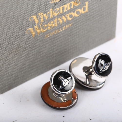 1141 - VIVIENNE WESTWOOD - a pair of modern black mother-of-pearl Orb cufflinks, chrome plated settings, pa... 