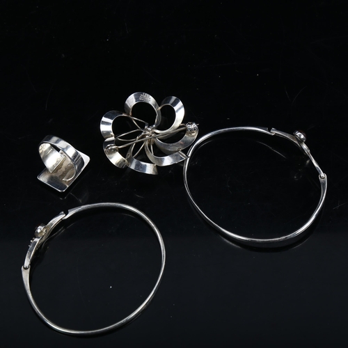 1145 - 2 sterling silver amber bangles, a Danish silver brooch, and a Niels Erik From ring (4)