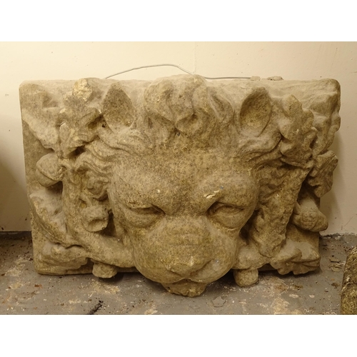 2715 - A weathered concrete lion mask wall hanging sculpture, H35cm