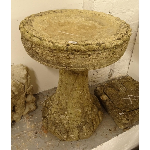 2716 - A weathered concrete garden bird bath, H56cm, and a small pedestal