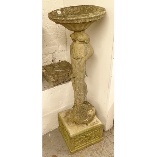 2717 - A weathered concrete garden bird bath on figural stand, with associated plinth, H116cm