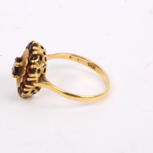 1156 - An 18ct gold garnet oval cluster ring