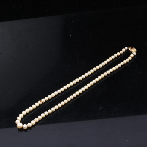 1187 - A single-strand graduated pearl necklace, with garnet 9ct gold clasp