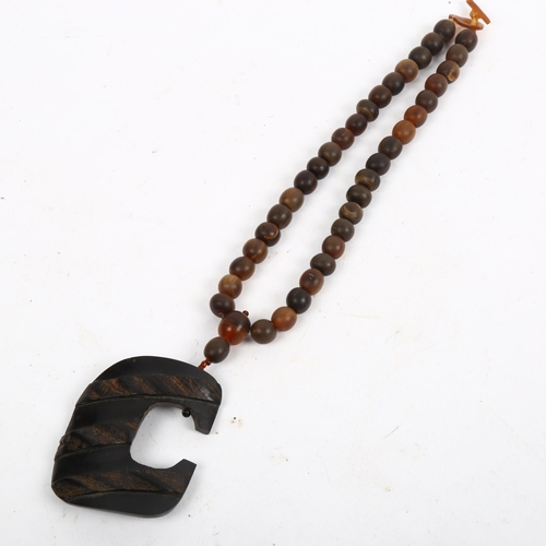 1201 - A large carved horn bead pendant necklace