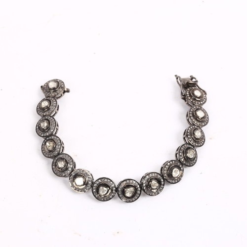 1208 - A modern unmarked oxidised silver diamond cluster bracelet, set with table and rose-cut diamonds, to... 