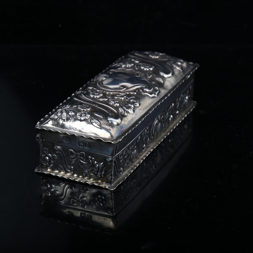 1218 - A late Victorian silver rectangular dressing table box, relief embossed floral decoration, by Willia... 