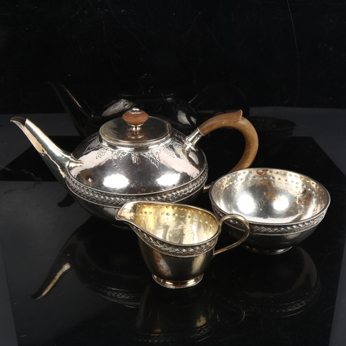 1258 - An Arts and Crafts 3-piece silver tea set, squat form with allover planished decoration, and woven w... 