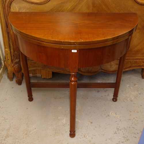 2673 - A mahogany bow-front fold over card table, H79cm