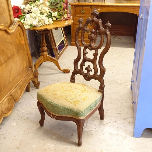 2676 - A French Gothic design nursing chair, with a carved and pierced back, and needlepoint upholstered se... 