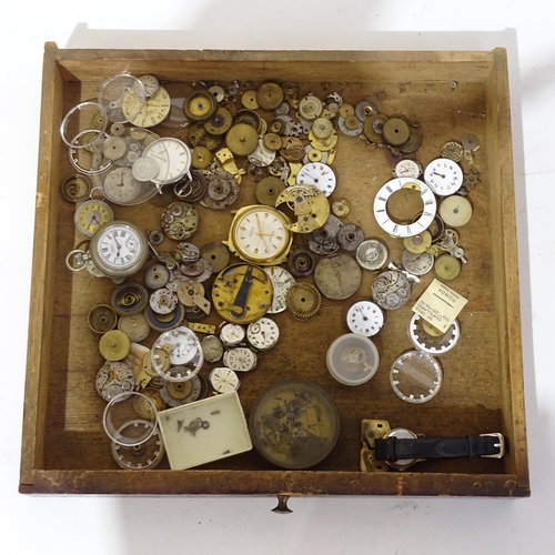 1107 - A Vintage watchmaker's table-top chest of drawers, containing a large quantity of various parts and ... 