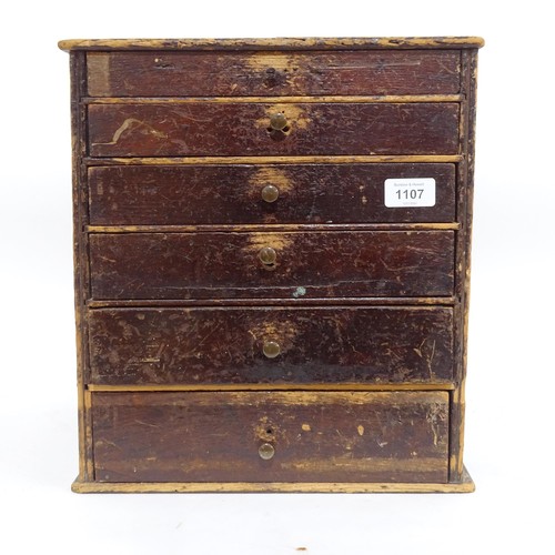 1107 - A Vintage watchmaker's table-top chest of drawers, containing a large quantity of various parts and ... 