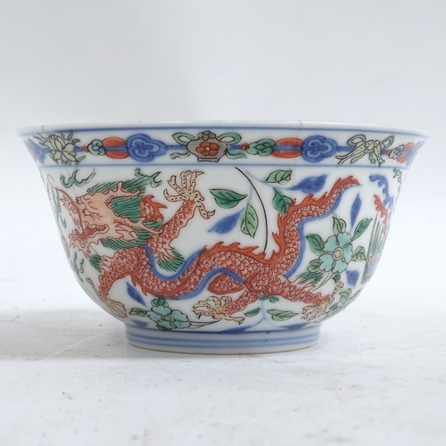 448 - A Chinese Doucai 'dragon and phoenix' porcelain bowl, depicting 5-claw dragon chasing flaming pearl,... 