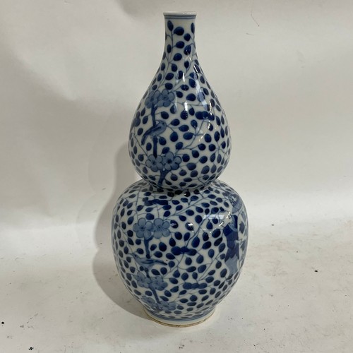 363 - A Chinese blue and white double-gourd vase, figural and floral decoration with jars, height 29cm