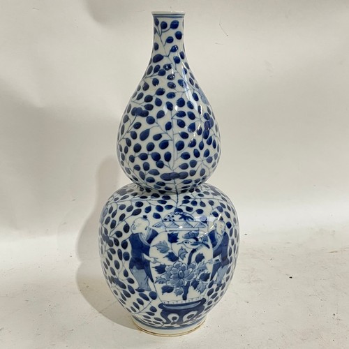 363 - A Chinese blue and white double-gourd vase, figural and floral decoration with jars, height 29cm