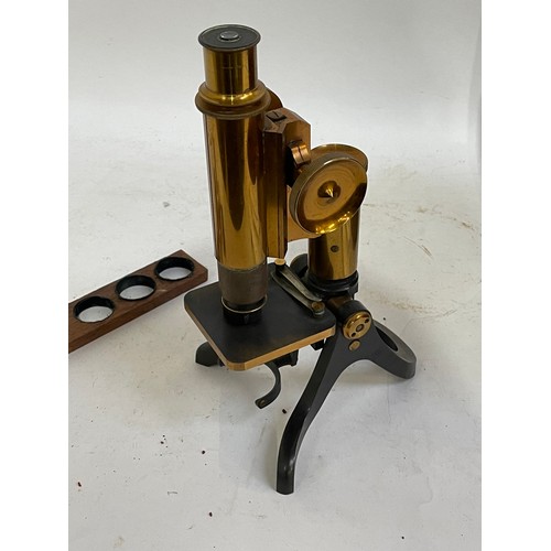 144A - A Victorian brass binocular microscope, with a box of slides and extra fittings, in original mahogan... 