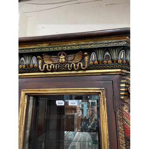 2004 - An Egyptian Revival design display cabinet, with a single-glazed and panelled cupboard door, and all... 