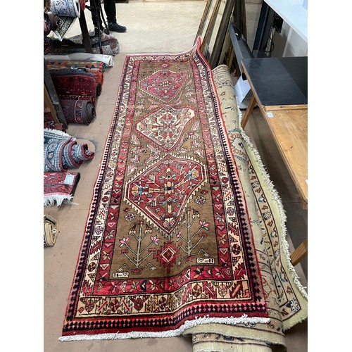 2391 - A red ground Karajeh runner, 305cm x 100cm