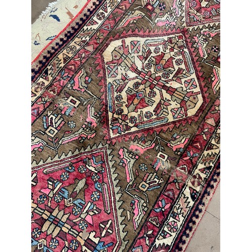 2391 - A red ground Karajeh runner, 305cm x 100cm