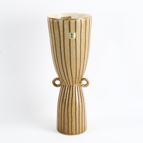 1570 - A mid-century Japanese Tokoname Hishoku Gama vase with pinched waist and small ring handles, paper l... 