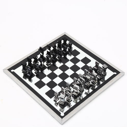 1614 - A 1960s' modernist chess set by ALCAN, France, aluminium pieces with aluminium framed mirror board, ... 