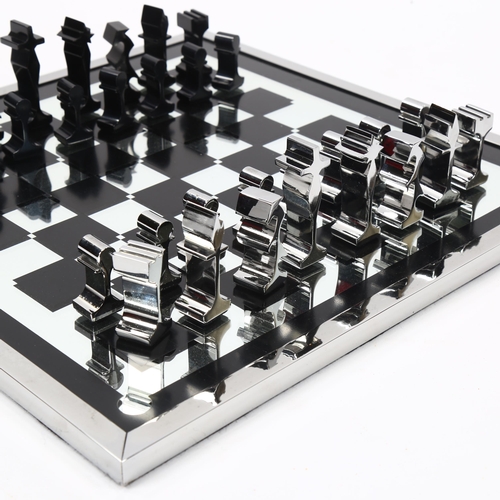 1614 - A 1960s' modernist chess set by ALCAN, France, aluminium pieces with aluminium framed mirror board, ... 