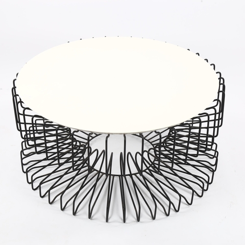 1627 - A mid-century coffee table with wire framed base and resin top, diam 80cm.