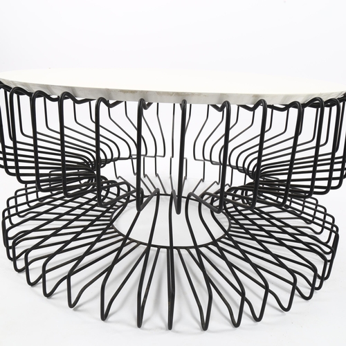 1627 - A mid-century coffee table with wire framed base and resin top, diam 80cm.