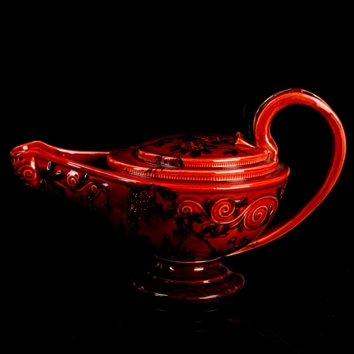 1015 - GEORGE JONES for MELROSE WARE - a Victorian red glaze earthenware pottery oil lamp, circa 1898, list... 