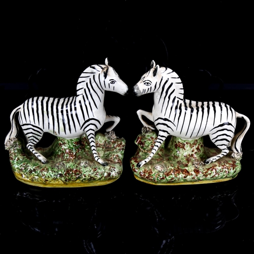 1033 - A pair of Staffordshire pottery zebra figures, height 19.5cm