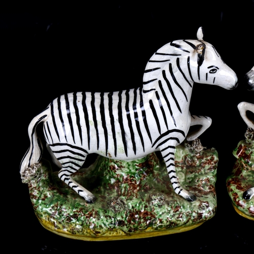 1033 - A pair of Staffordshire pottery zebra figures, height 19.5cm