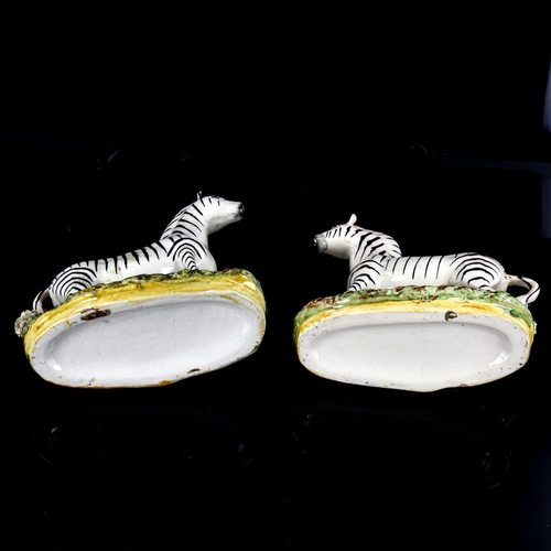 1033 - A pair of Staffordshire pottery zebra figures, height 19.5cm