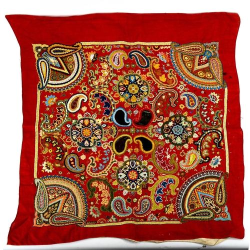 1039 - A 19th century Indian hand embroidered panel on red ground, approx 80cm x 70cm