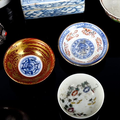 1064 - A group of Oriental items, including porcelain tea bowls, unmarked white metal snuff bottle, bronze ... 