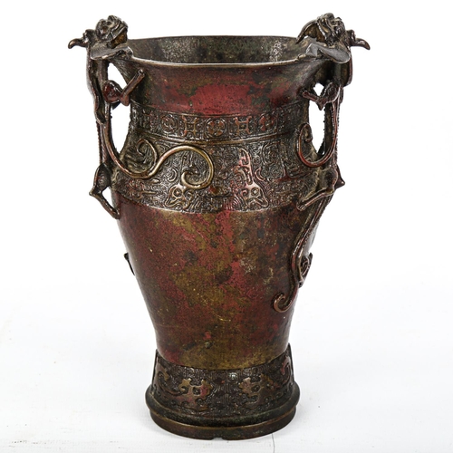 1075 - A Chinese Ming Dynasty patinated bronze vase, with dragon decorated handles and impressed bands, hei... 