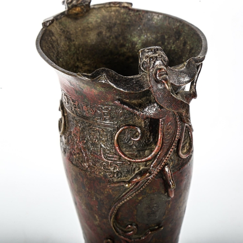 1075 - A Chinese Ming Dynasty patinated bronze vase, with dragon decorated handles and impressed bands, hei... 