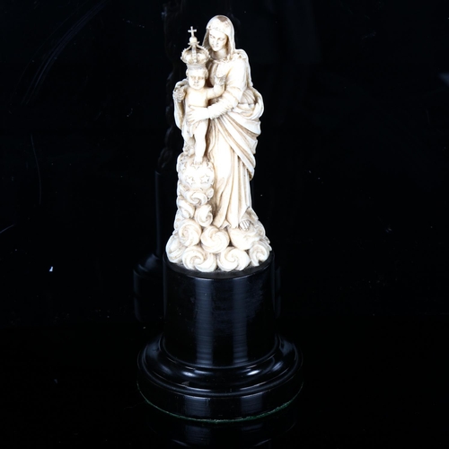 1077 - A carved ivory figure of Mary with the Infant Christ, 18th or 19th century, on ebonised wood plinth ... 