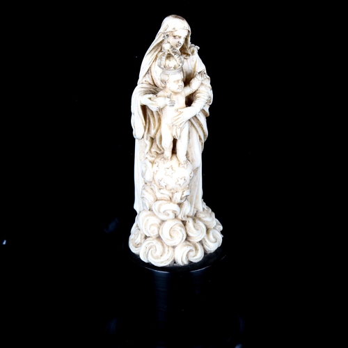 1077 - A carved ivory figure of Mary with the Infant Christ, 18th or 19th century, on ebonised wood plinth ... 