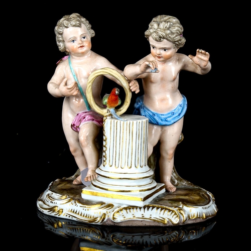 1085 - A Meissen porcelain group of 2 putti with a parrot, height 12cm