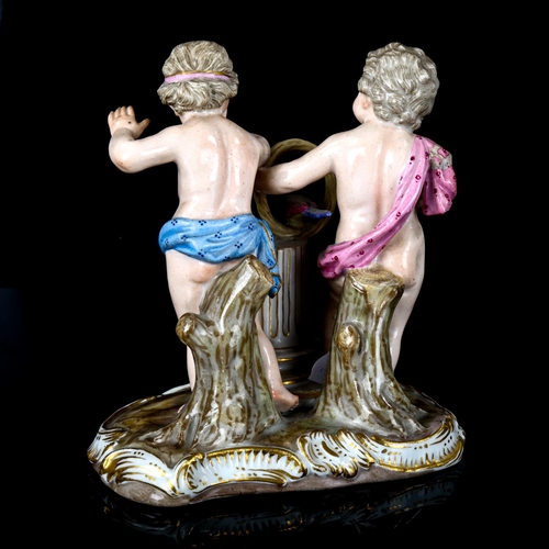 1085 - A Meissen porcelain group of 2 putti with a parrot, height 12cm