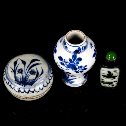 1128 - A Chinese dark green Peking overlay cameo glass snuff bottle, height 6.5cm, a miniature blue and whi... 