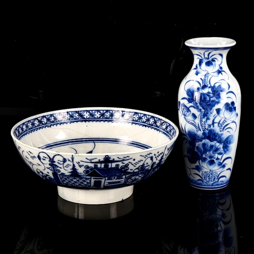 1135 - A Worcester tin glazed blue and white pottery bowl, diameter 26cm, and an Oriental blue and white va... 