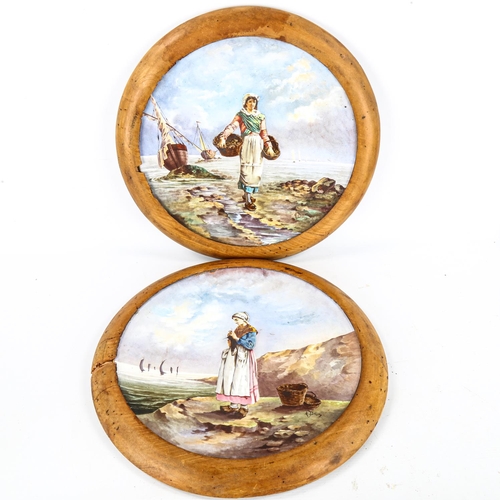 1143 - A pair of large 19th century French ceramic wall plates, with hand painted designs of fisher girls, ... 