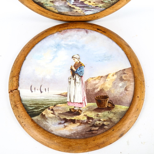 1143 - A pair of large 19th century French ceramic wall plates, with hand painted designs of fisher girls, ... 